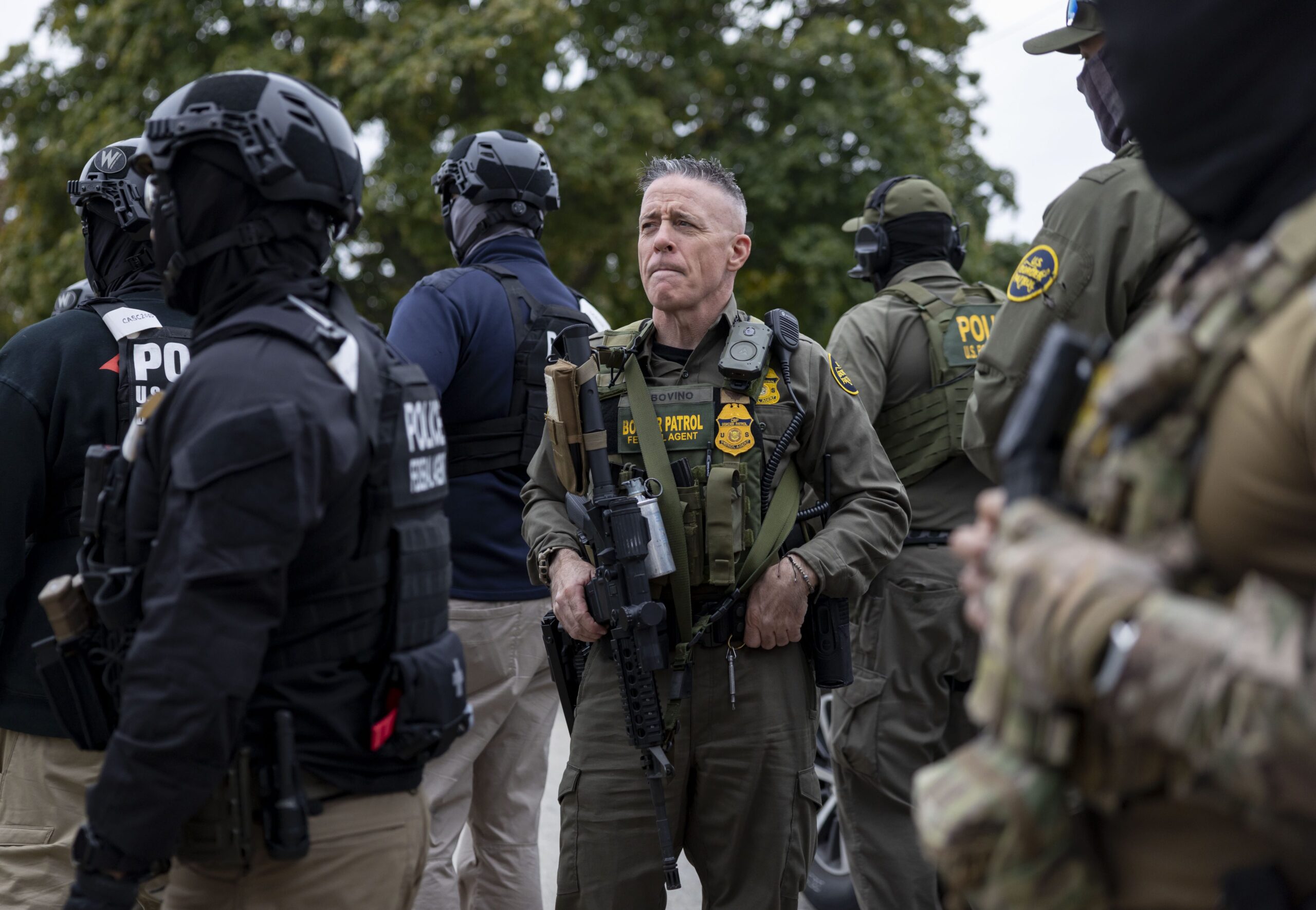 U.S. Border Patrol Cmdr. Gregory Bovino watches as agents detain...