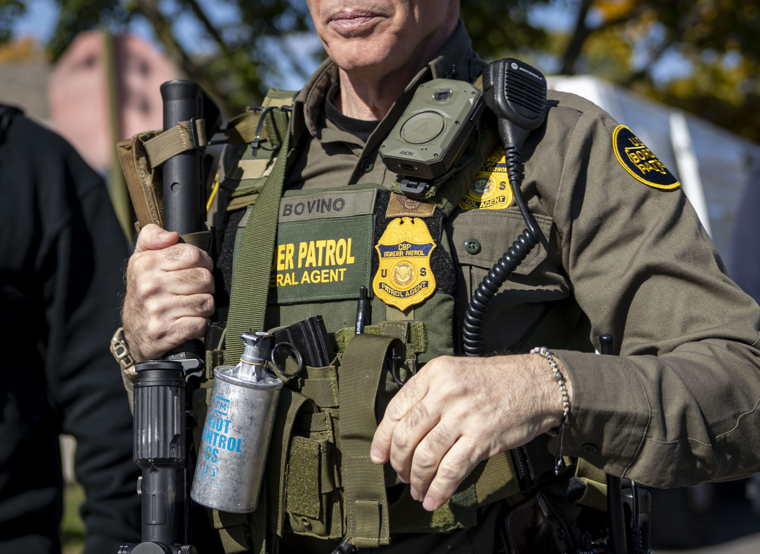 U.S. Border Patrol Cmdr. Gregory Bovino carries tear gas, a...