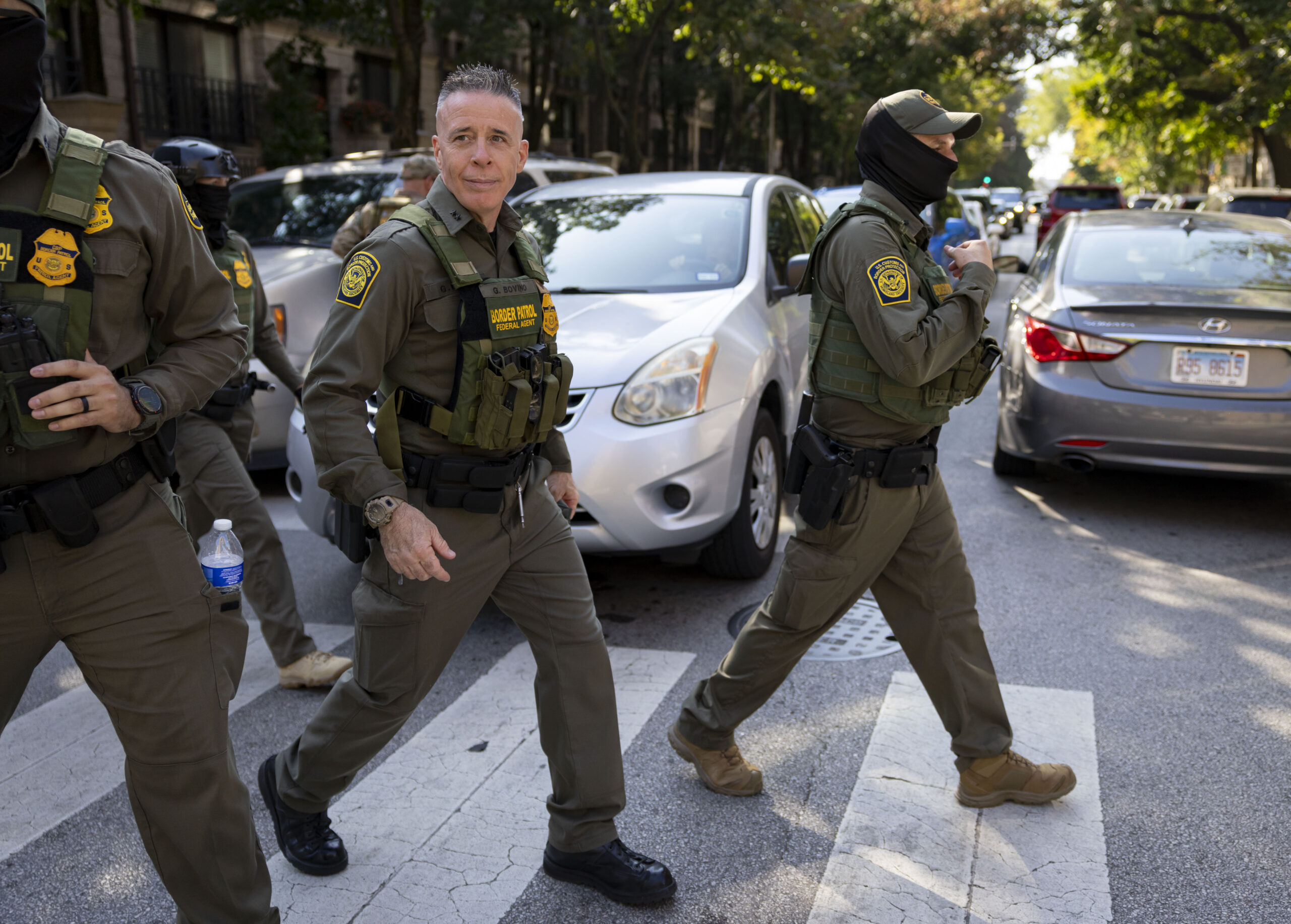 Border Control Cmdr. Gregory Bovino, center, walks with other federal...