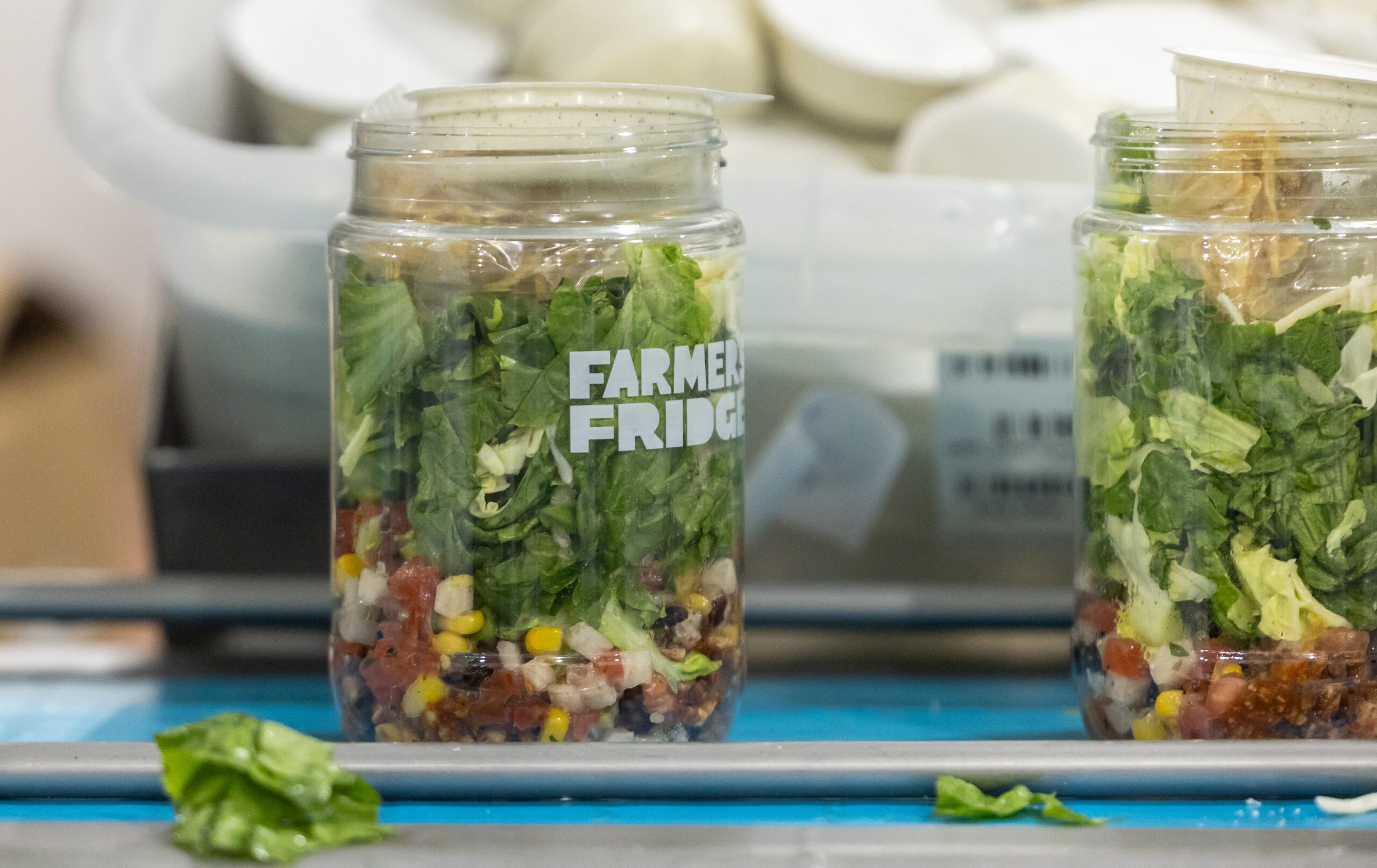 Southwest salad with chili lime chicken containers move along a...