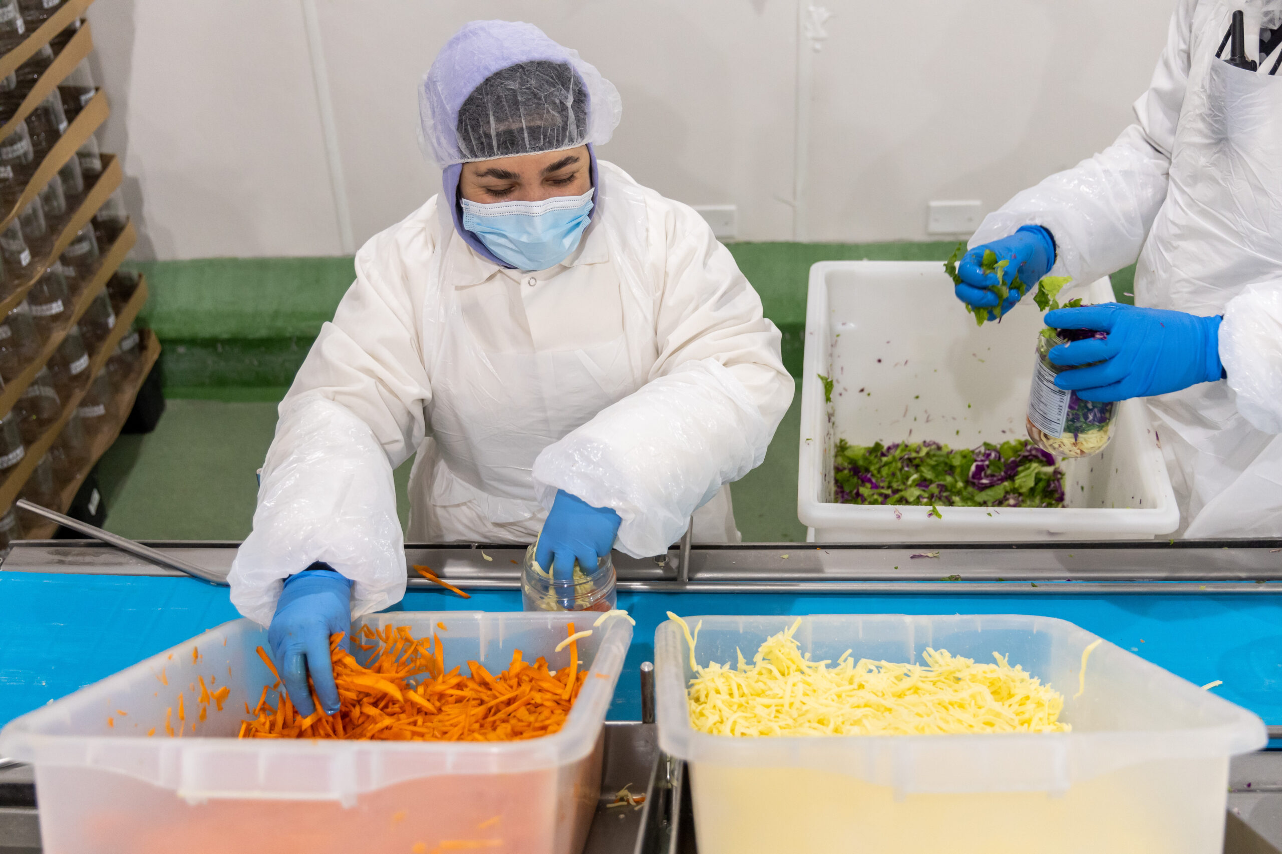 Chef salads are loaded into jars on Nov. 20, 2025,...