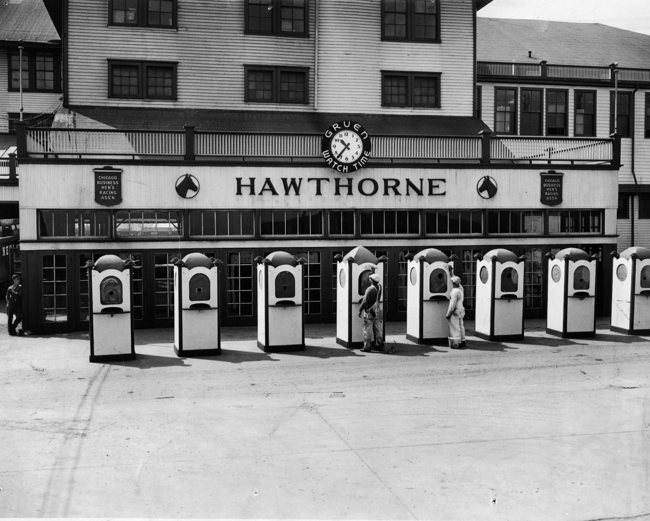 Painters put the finishing touches on ticket booths at Hawthorne...