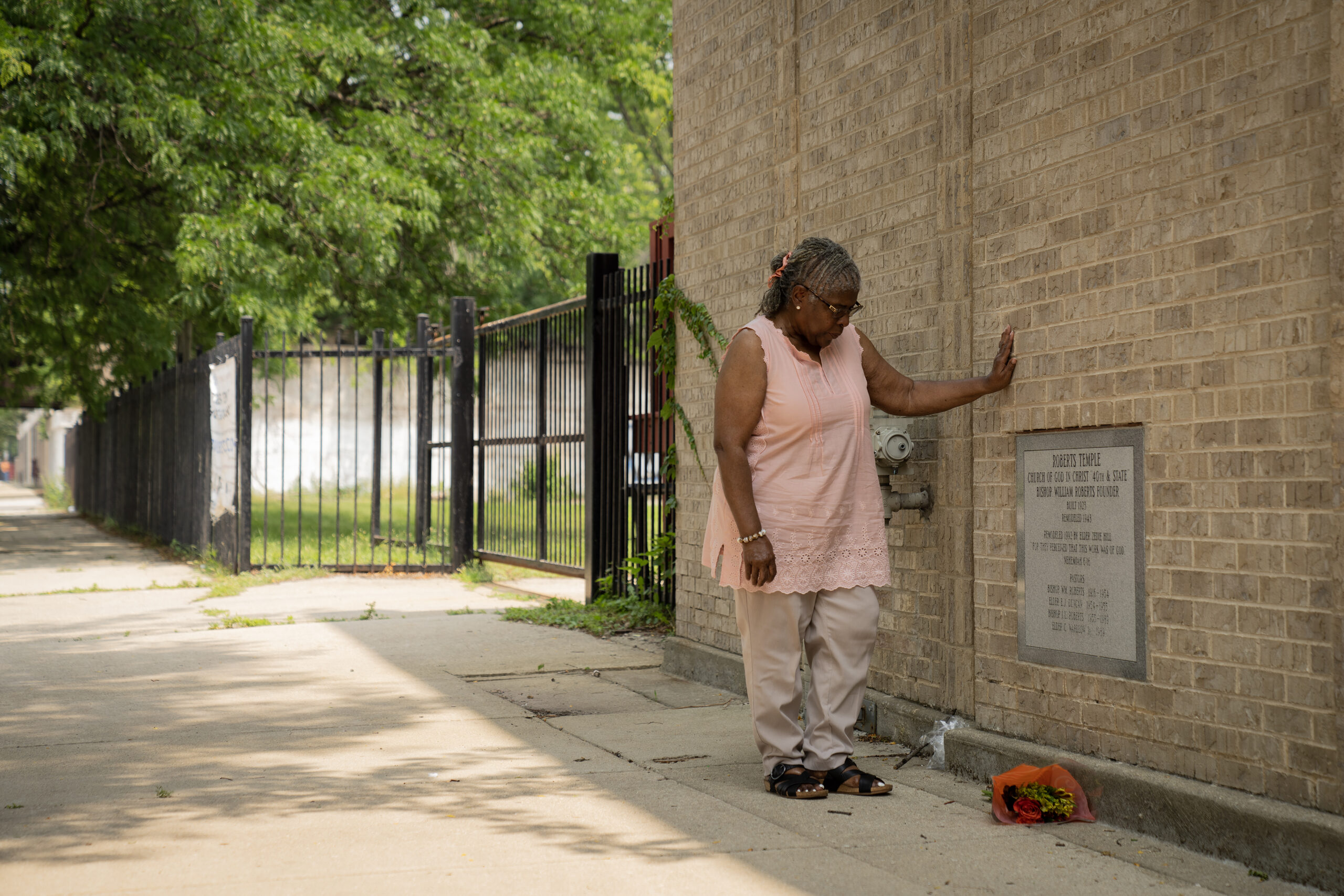 Beverly Love leaves a bouquet of flowers to mark Emmitt...