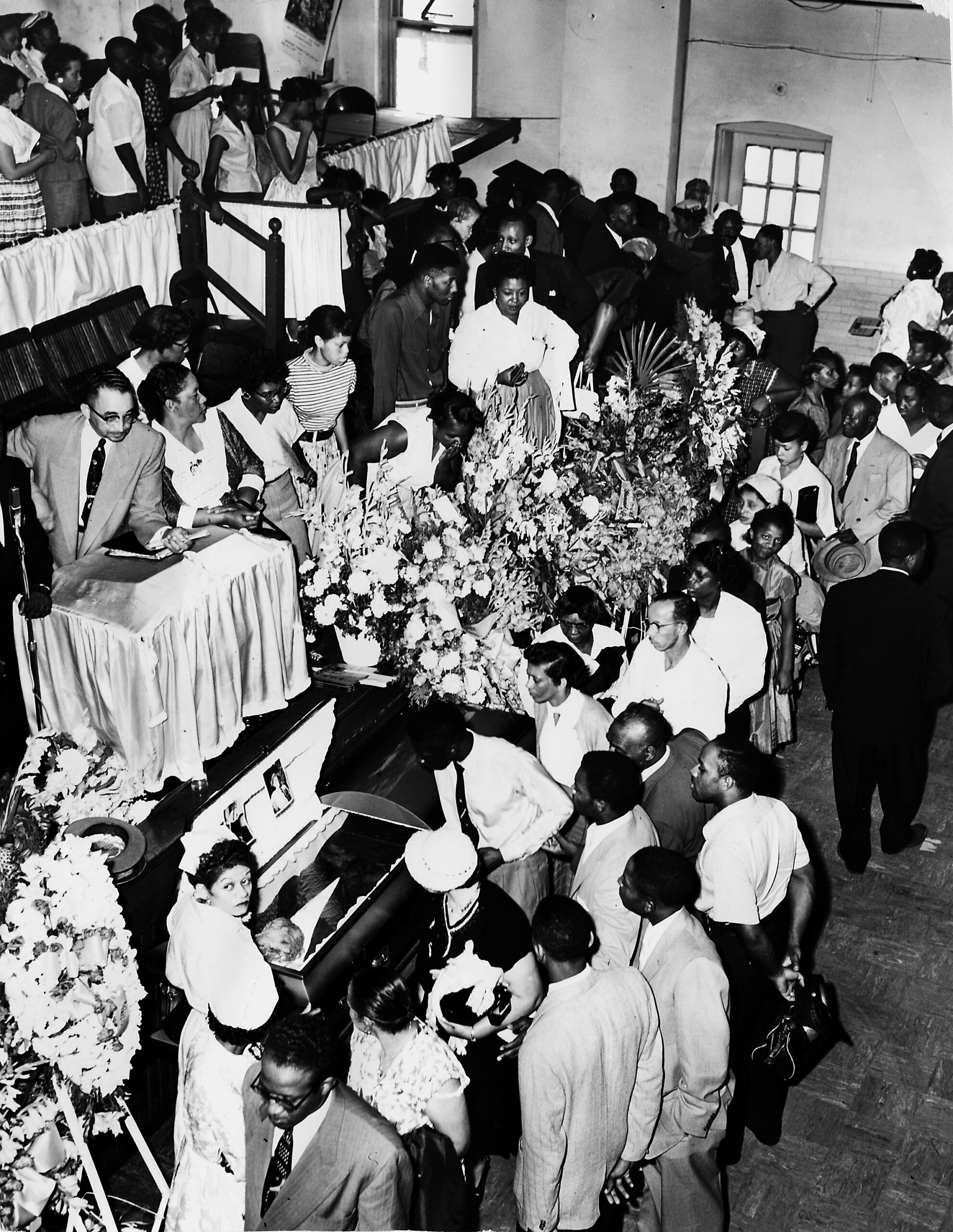 The crowd files past the open casket of Emmett Till...