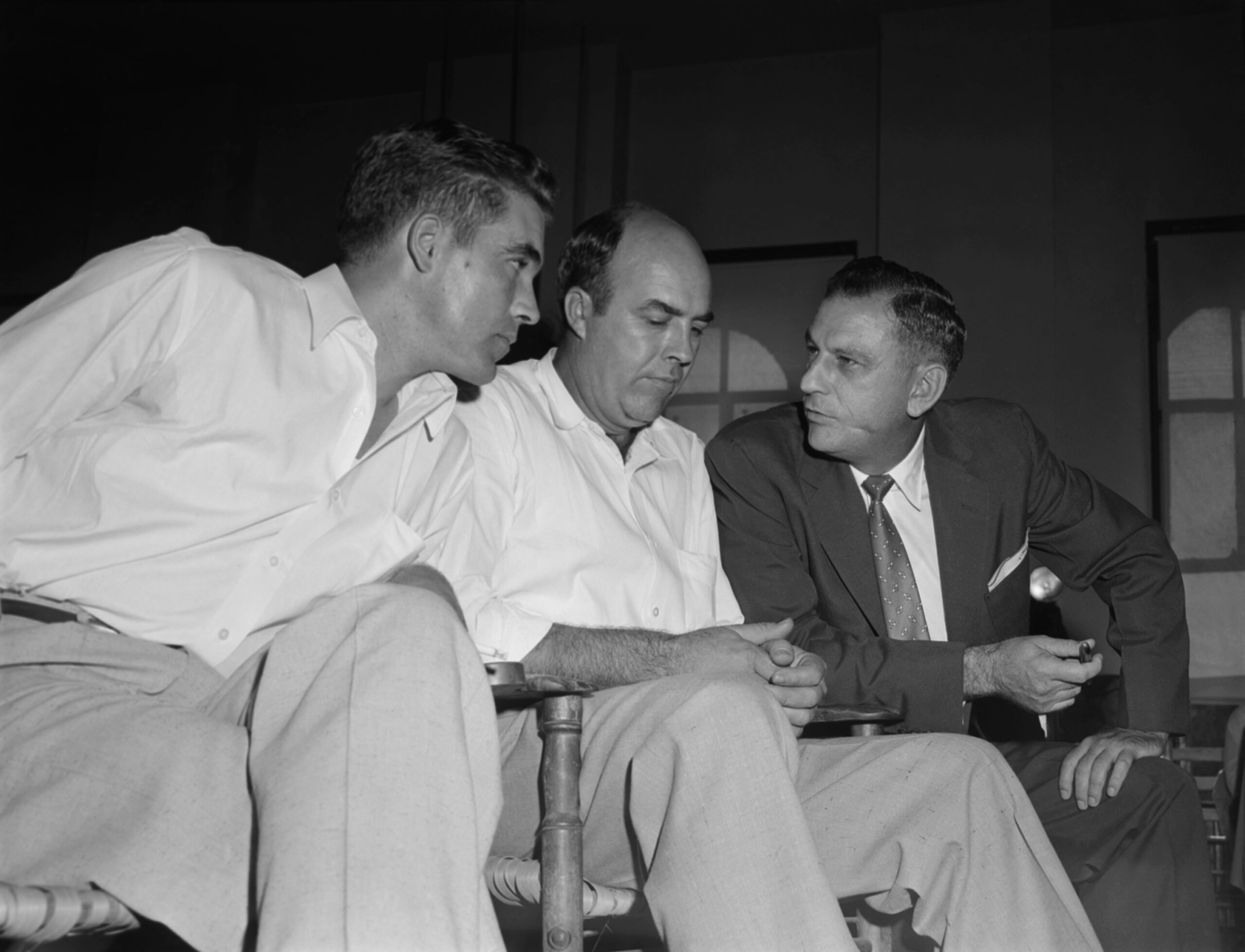 Half-brothers Roy Bryant, left, and J.W. Milam, center, listen to...