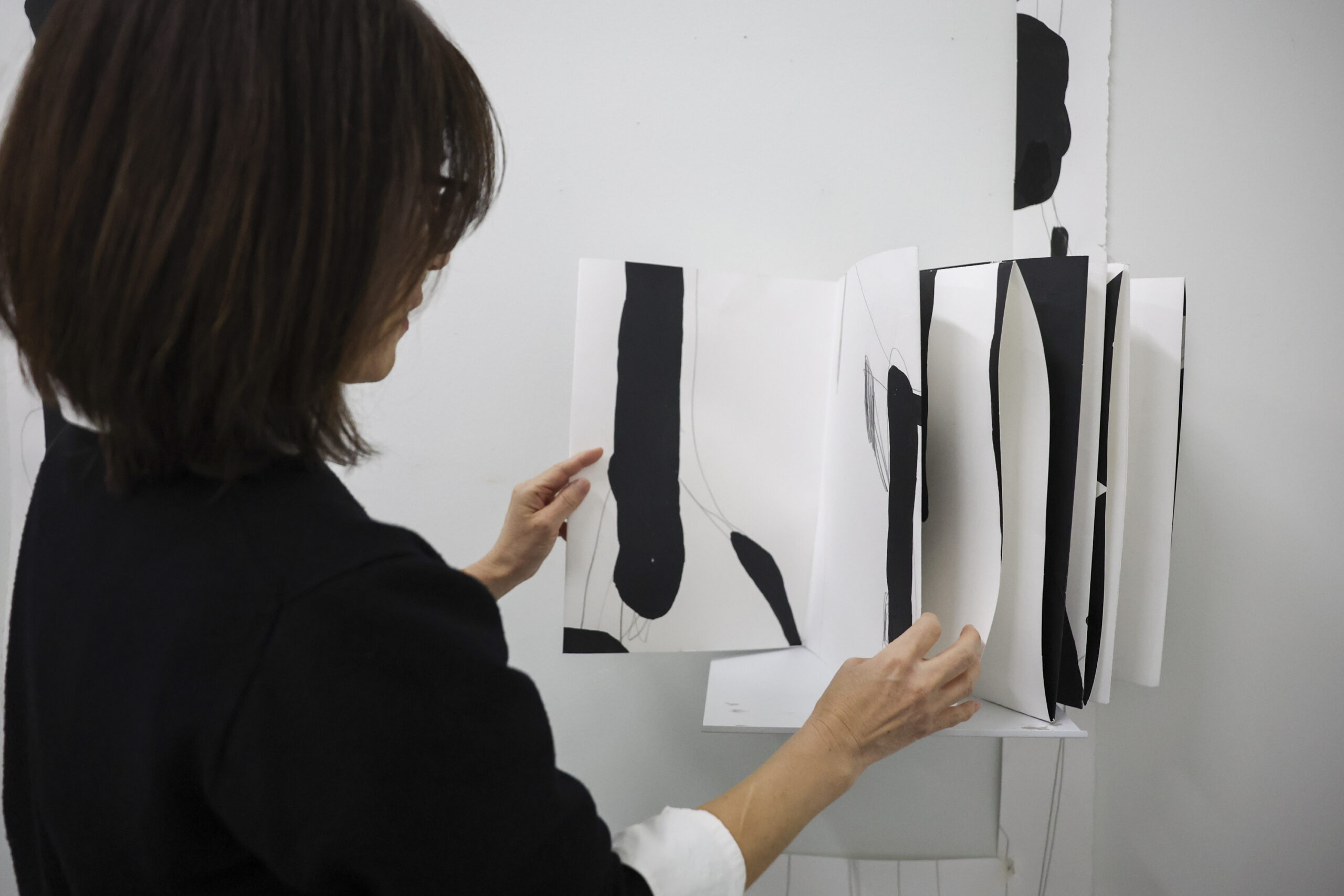 Yoonshin Park pages through a prototype of one of her...