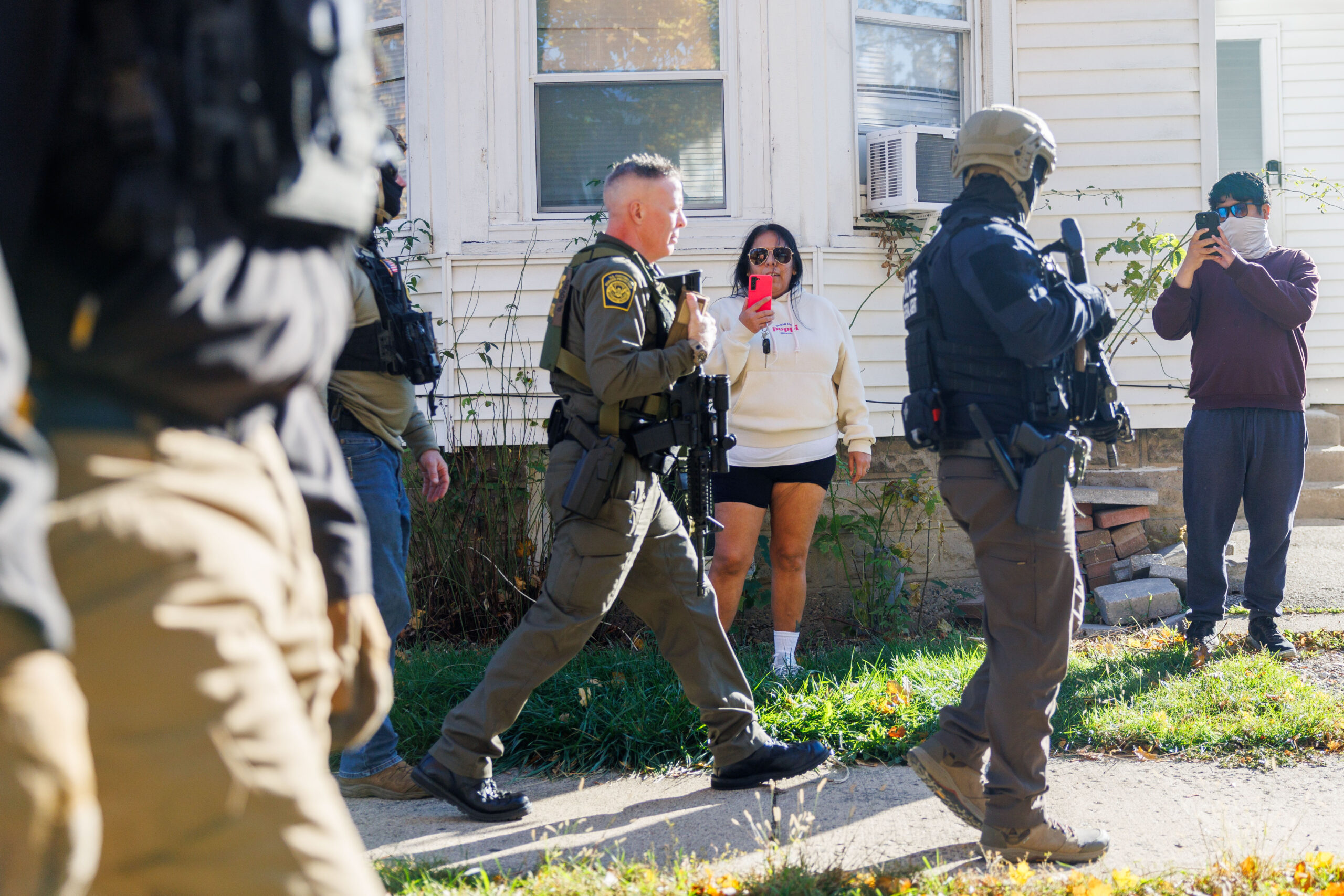 Members of the community yell at Border Patrol Cmdr. Gregory...