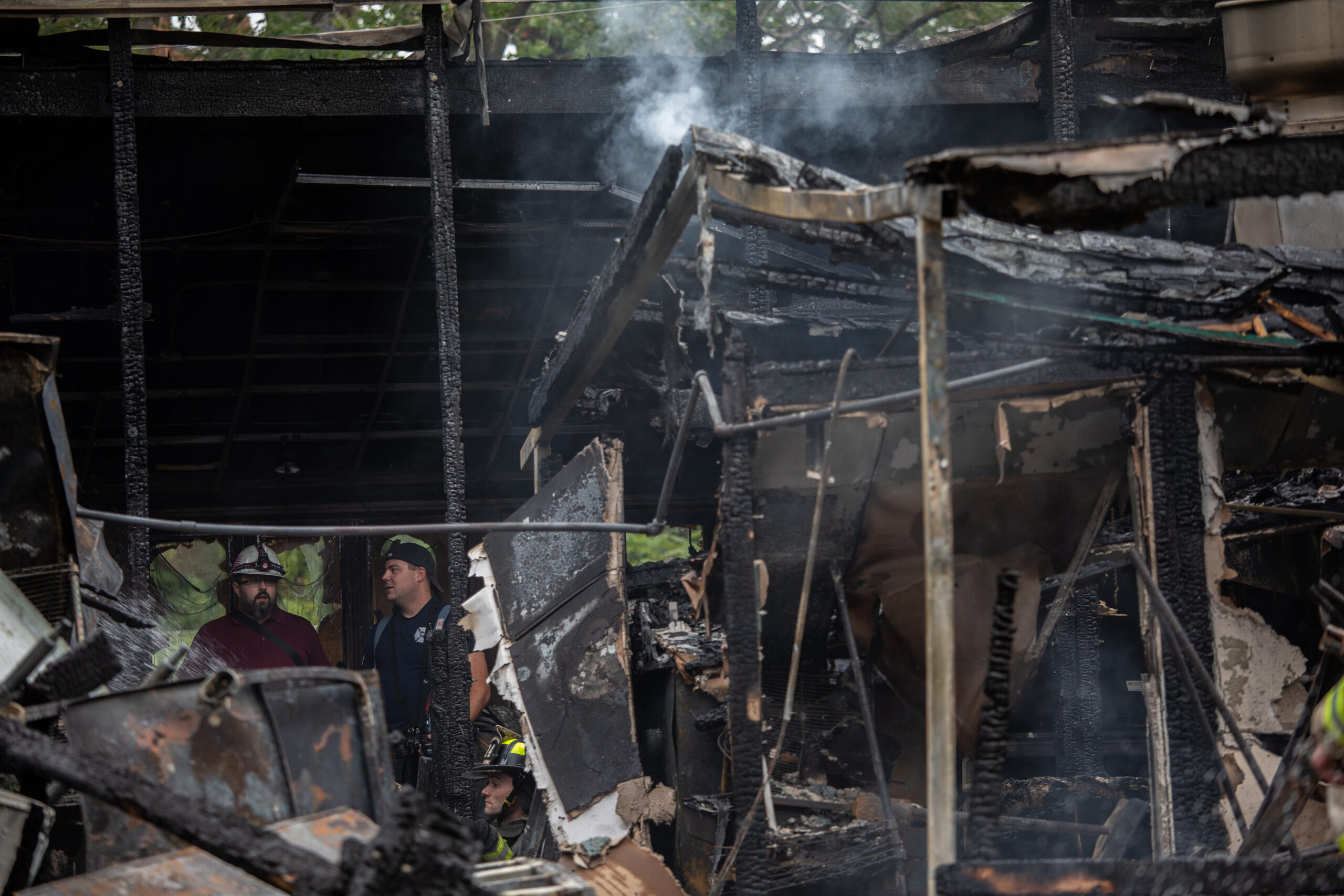 Firefighters and investigators work at the Maple Tree Inn following...